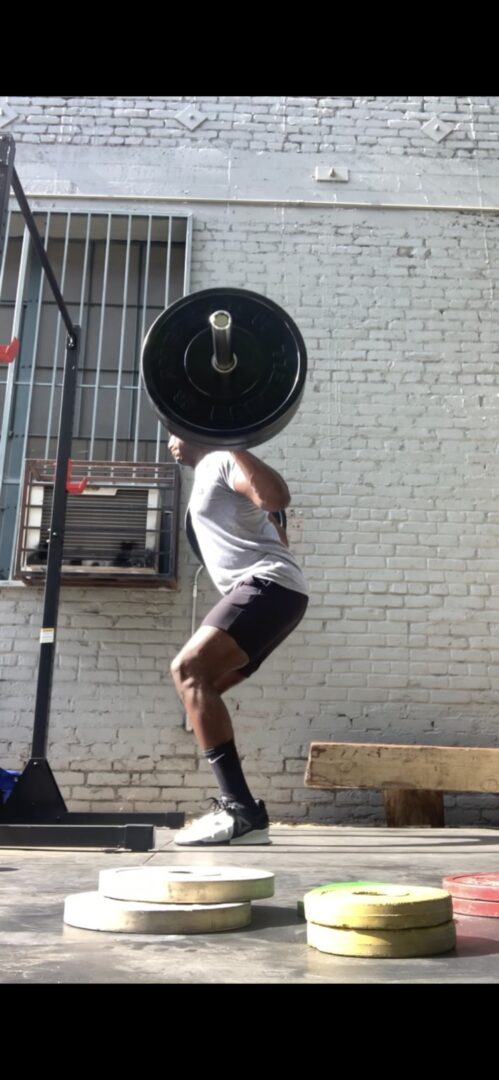 A person doing barbell squats