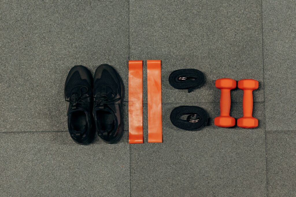 A pair of shoes and various workout equipment