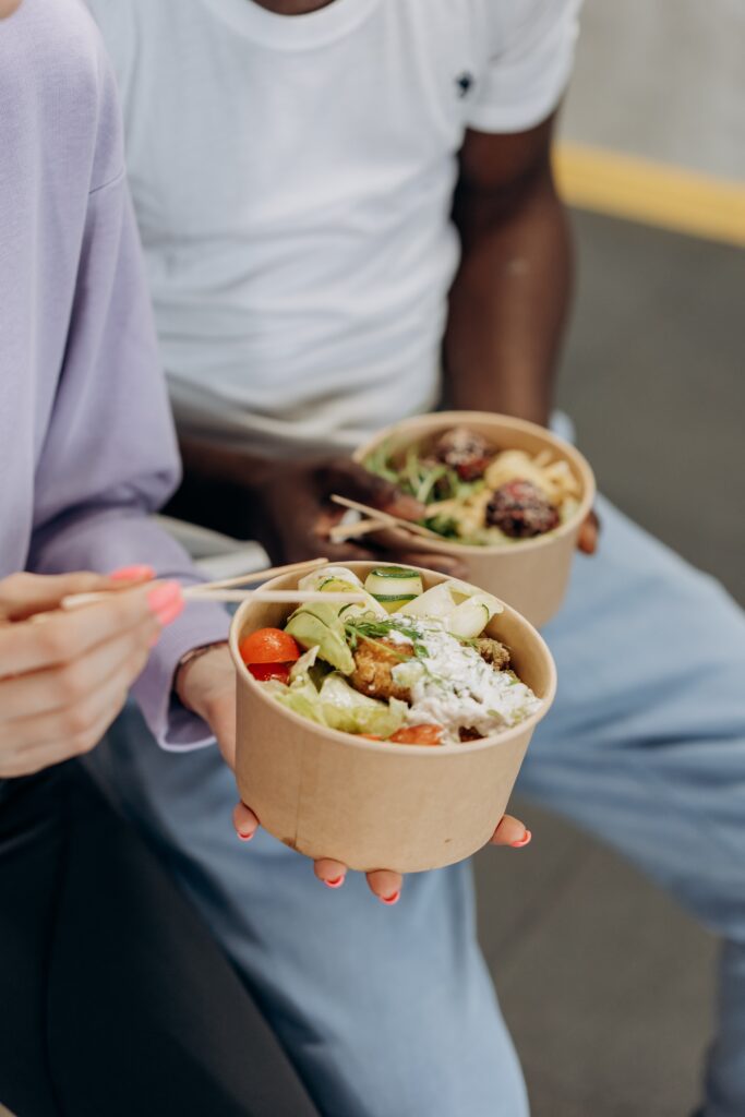 Two people eating salads