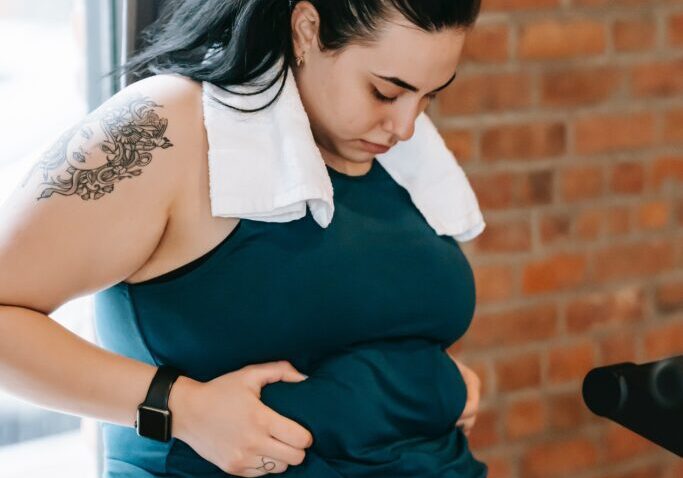 A woman squeezing her stomach