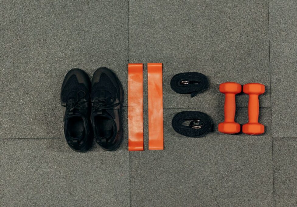 A pair of shoes and various workout equipment